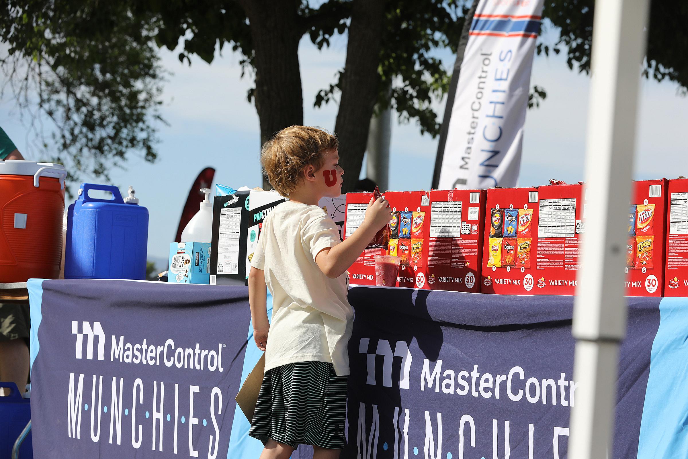 Kids Fun K participant getting snacks at MasterControl's "Munchies" table