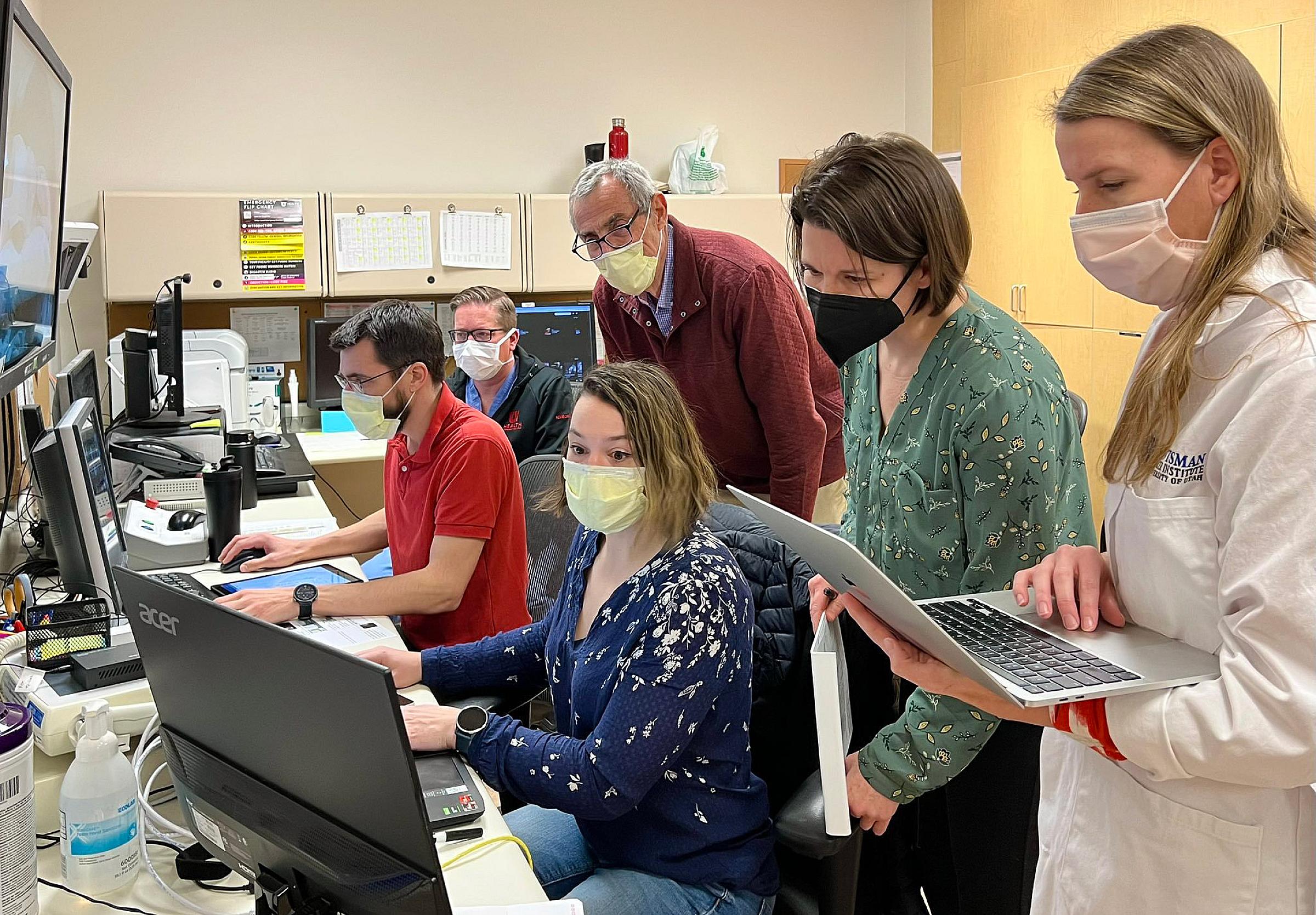 The team in the MRI control suite: (seated, left-to-right) Henrik Odéen, PhD, Derek Maxfield, Sara Johnson, PhD, (standing, left-to-right) Dennis Parker, PhD, Allison Payne, PhD, and Nicole Winkler, MD.