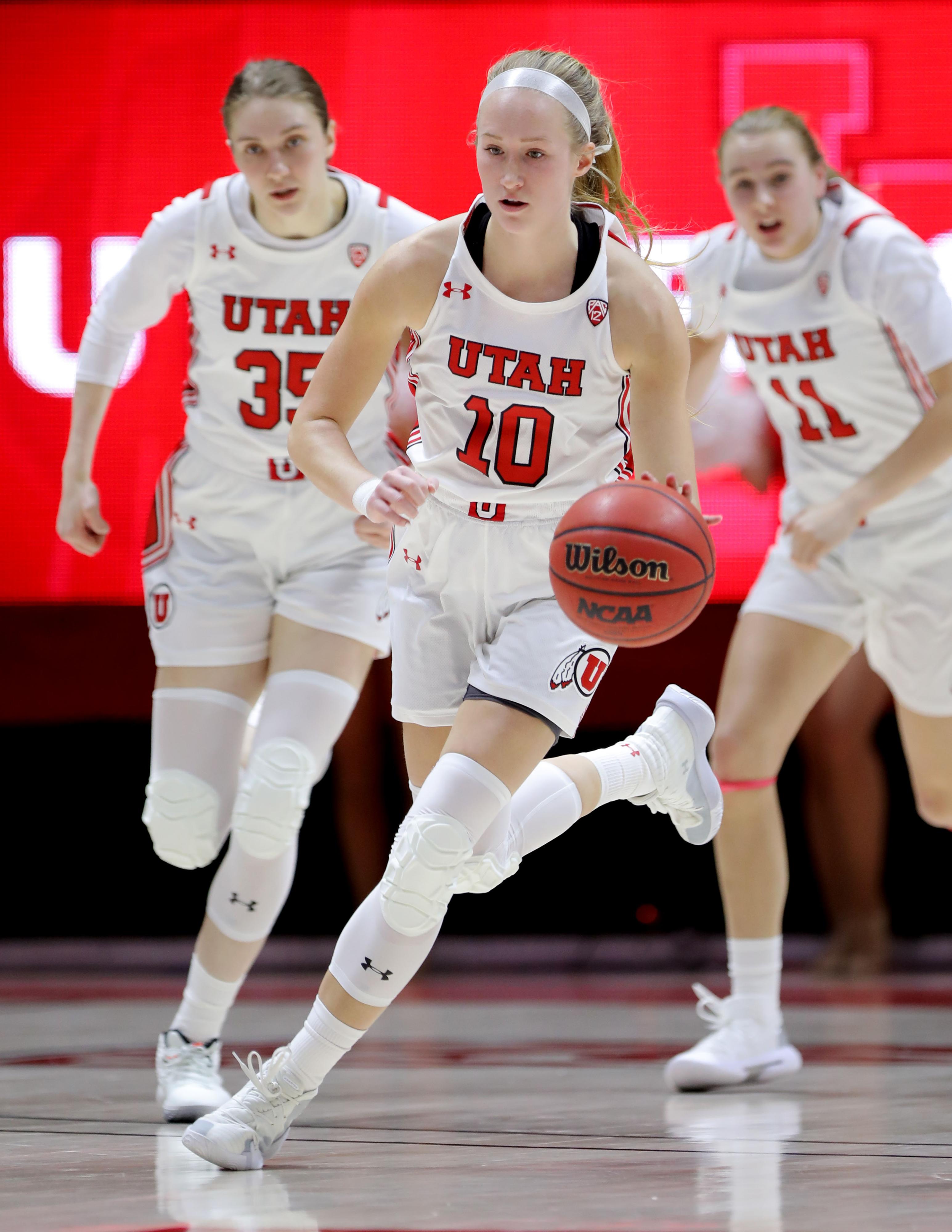 Picture of University of Utah Women's Basketball player, Dru Gylten, dribbling basketball on the court during a game
