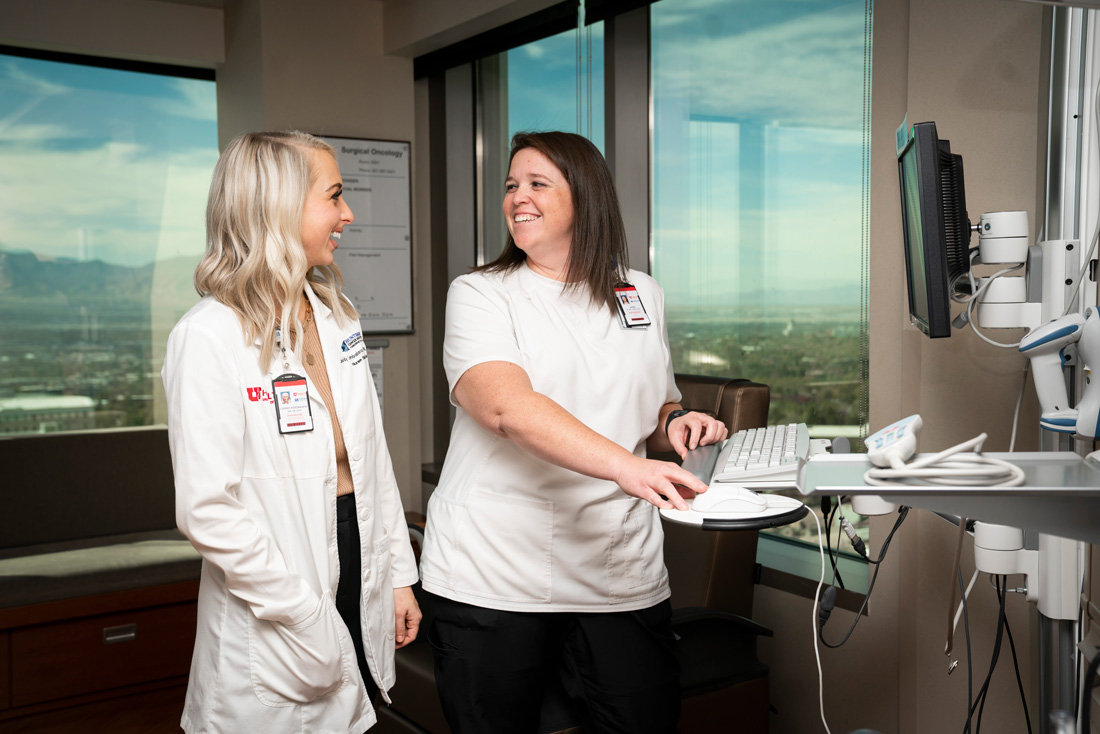 Nurse smiling at a computer station