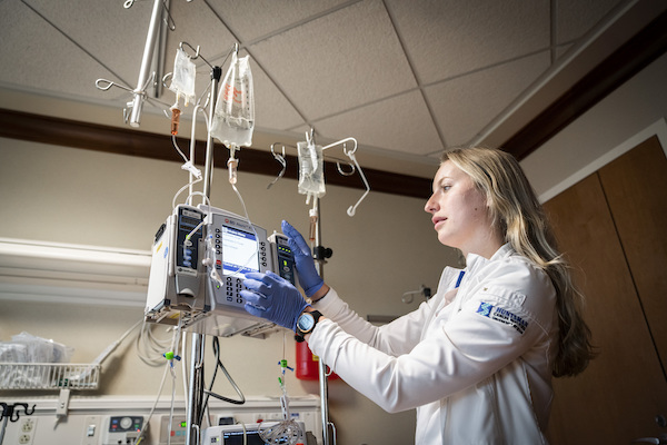 Nurse checking an IV machine