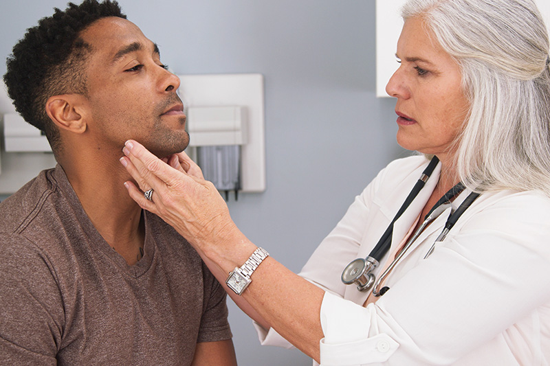 Provider examining a patient's neck
