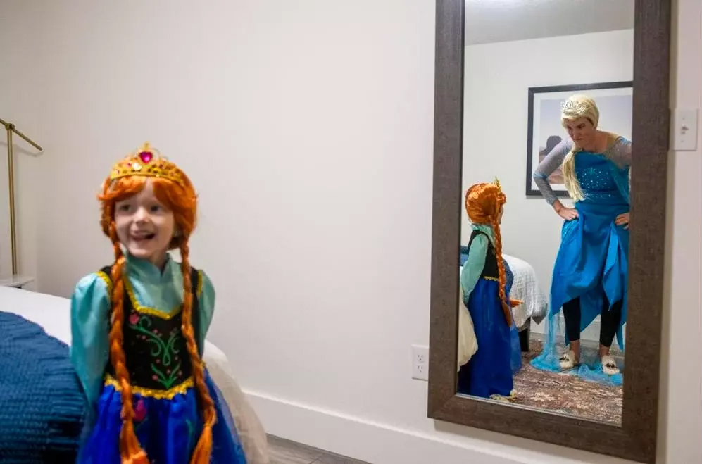 Dressed as Anna and Elsa from the Disney movie Frozen, Parker and Nicole practice get into character for a Halloween party at Huntsman Cancer Institute.