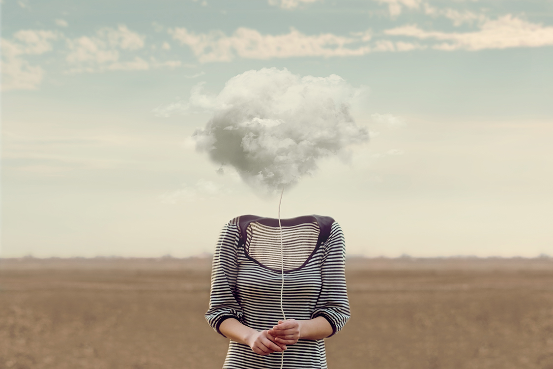 Woman holding a cloud on a string where her head should be