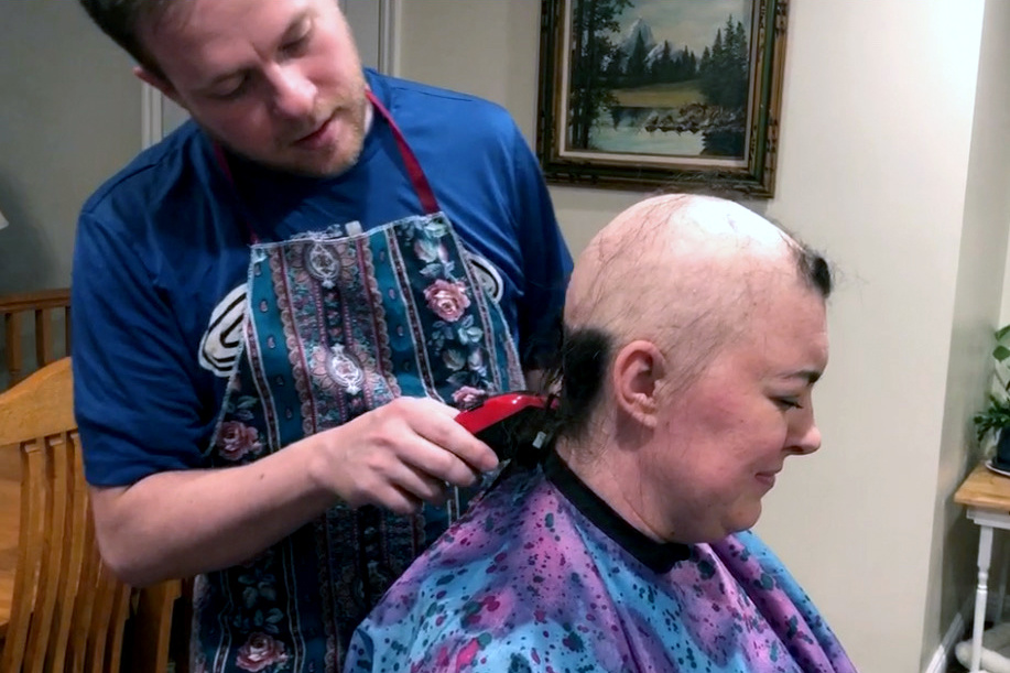 man shaving a woman's head