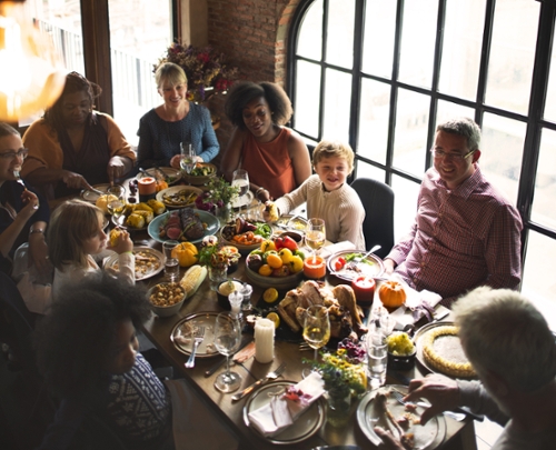 a family eats thanksgiving dinner together