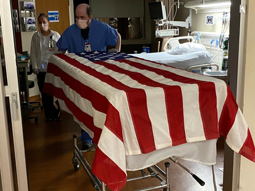 U.S. flag draped over hospital gurney