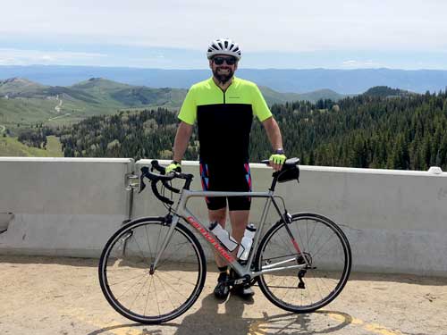 Max Rosett posing with bike on mountain road