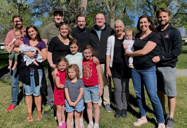 Pam poses for a family photo with her husband, children, and grandchildren
