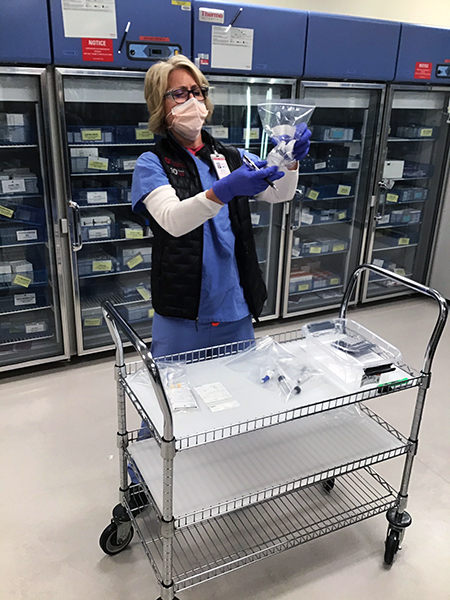 female pharmacist holding a bag of medication