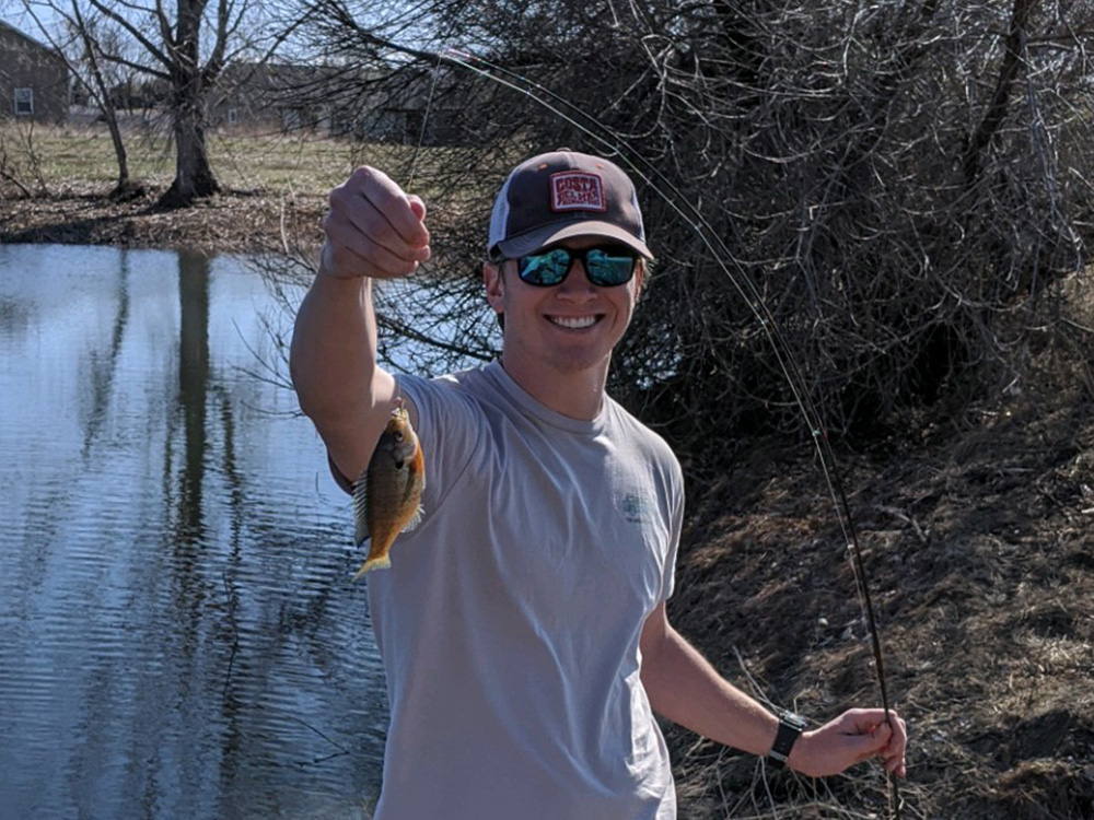 Trevor Schwehr holding up a fish he caught