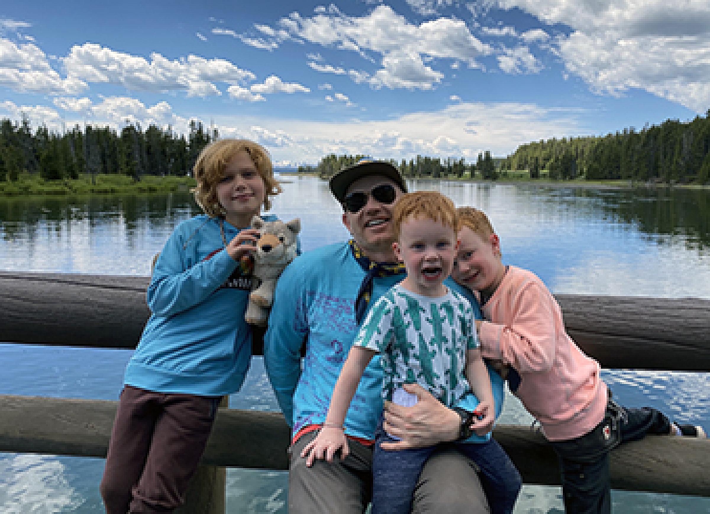 Brandon Plewe and three of his children at a lake