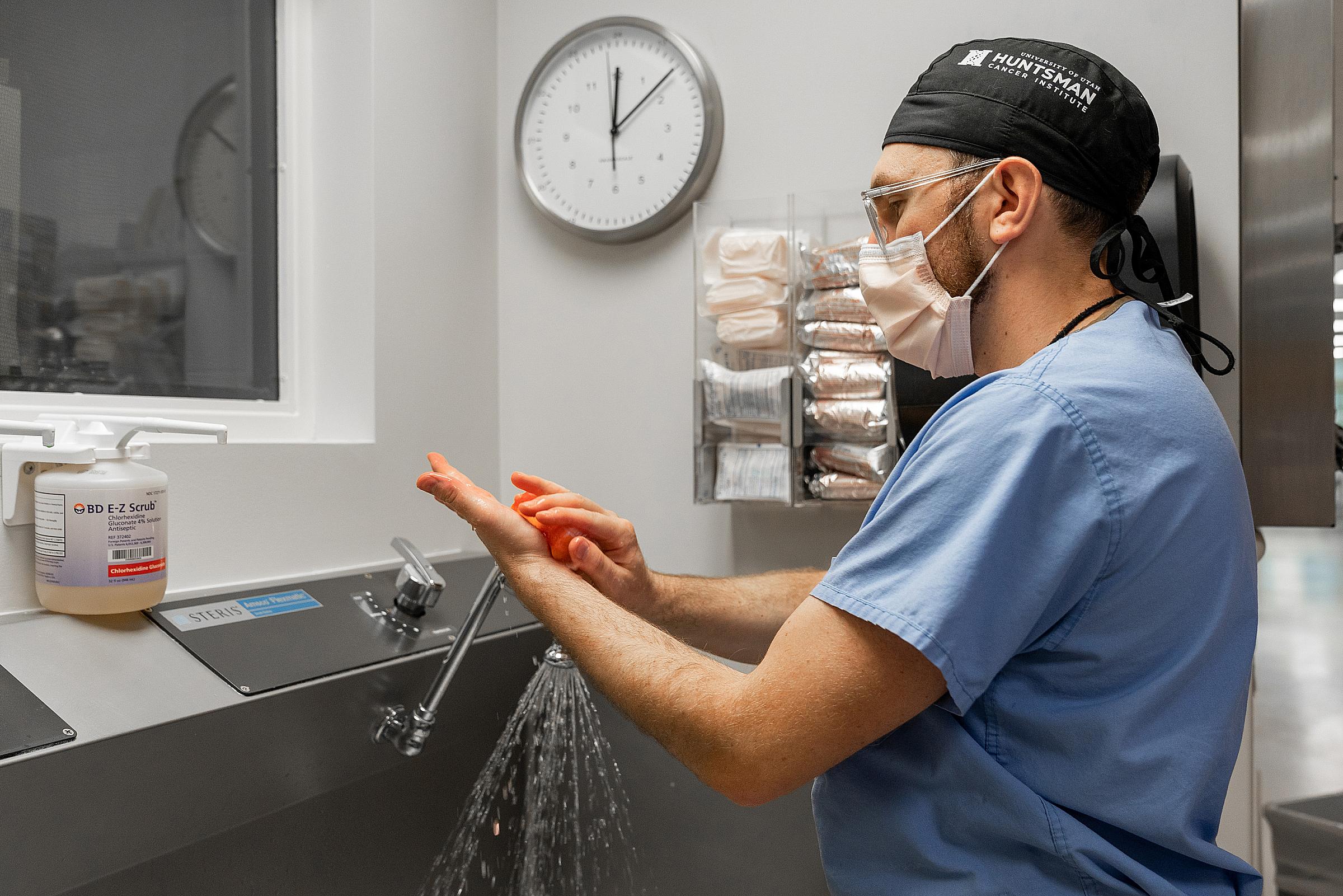 Brian Mitzman, MD scrubbing his hands prior to surgery