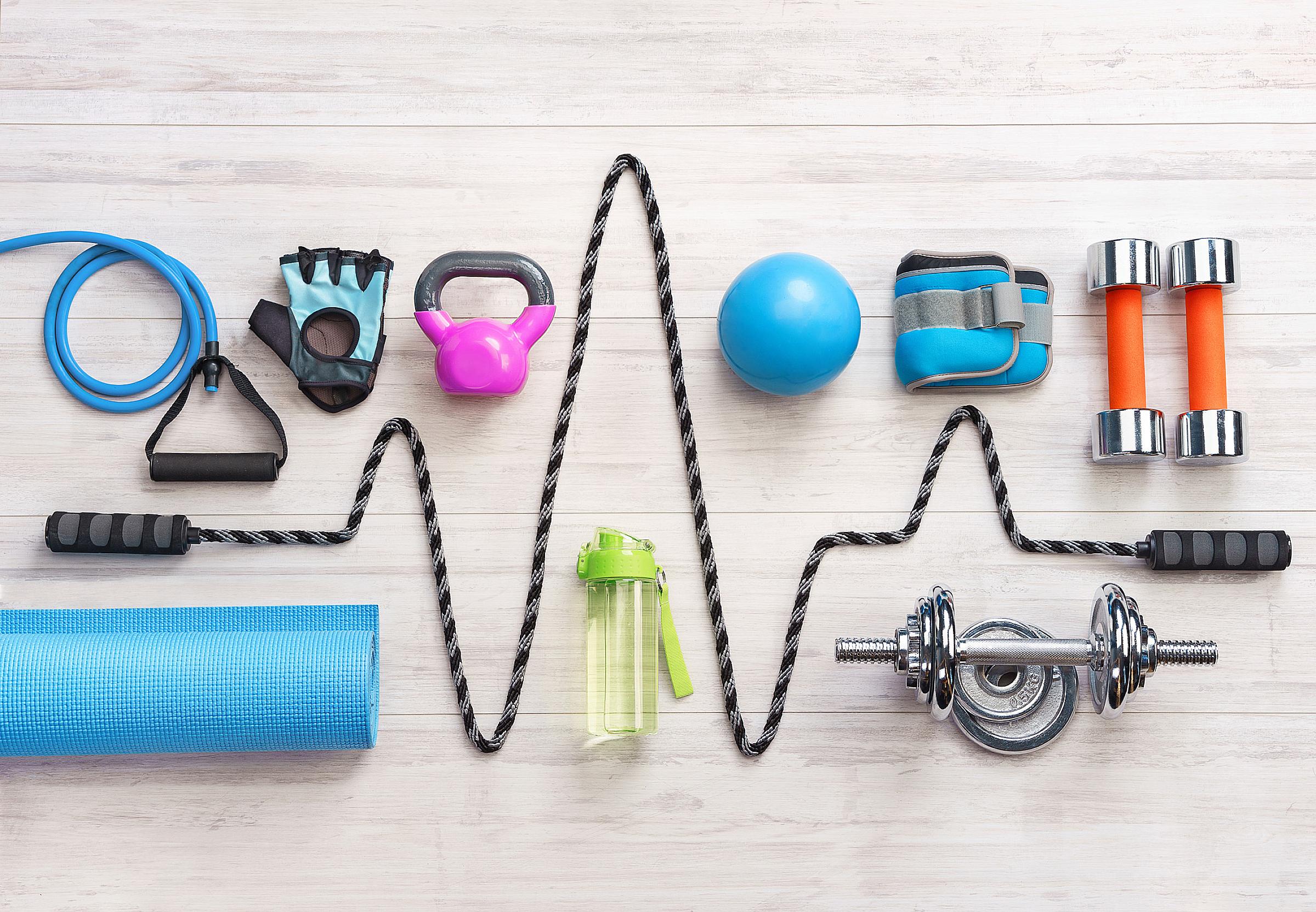 Various pieces of exercise equipment lined up on the floor