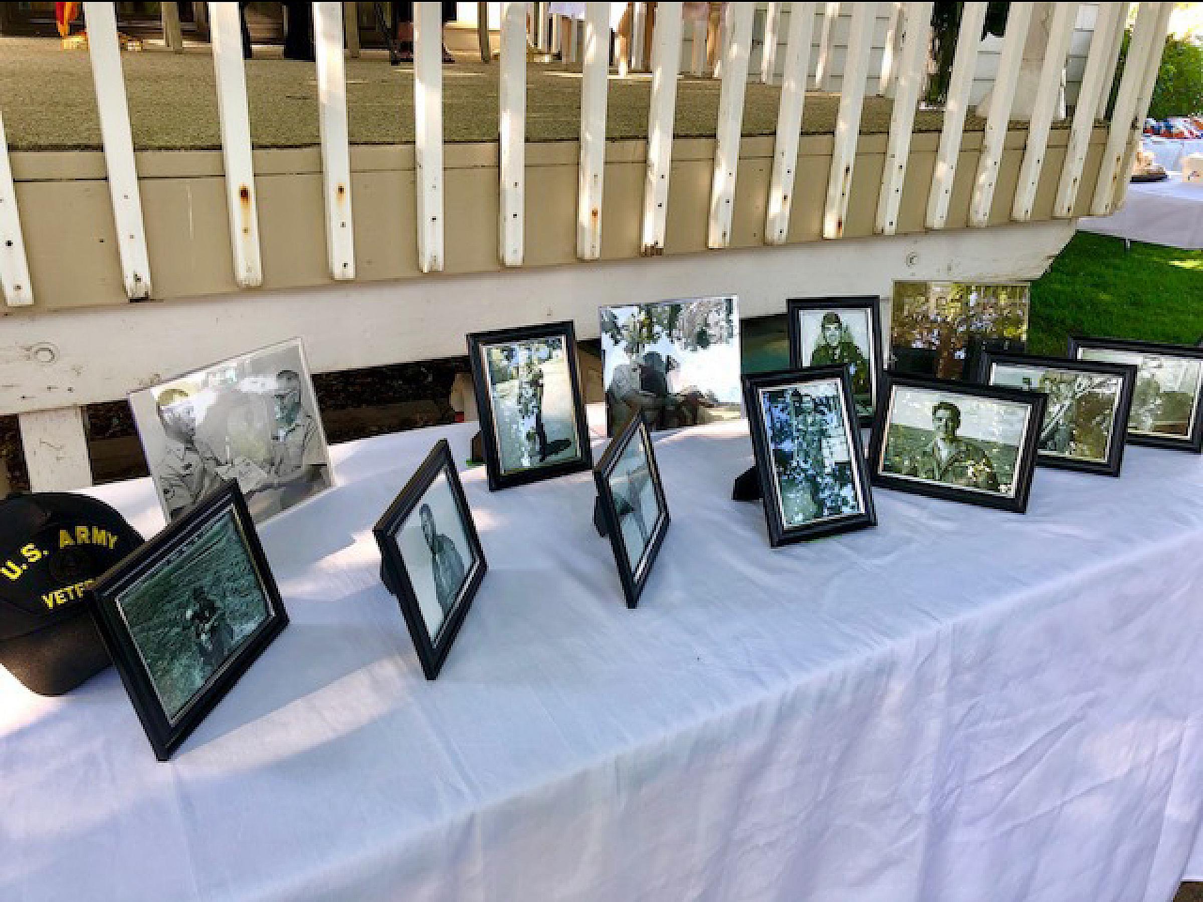 Framed photos of service men on table
