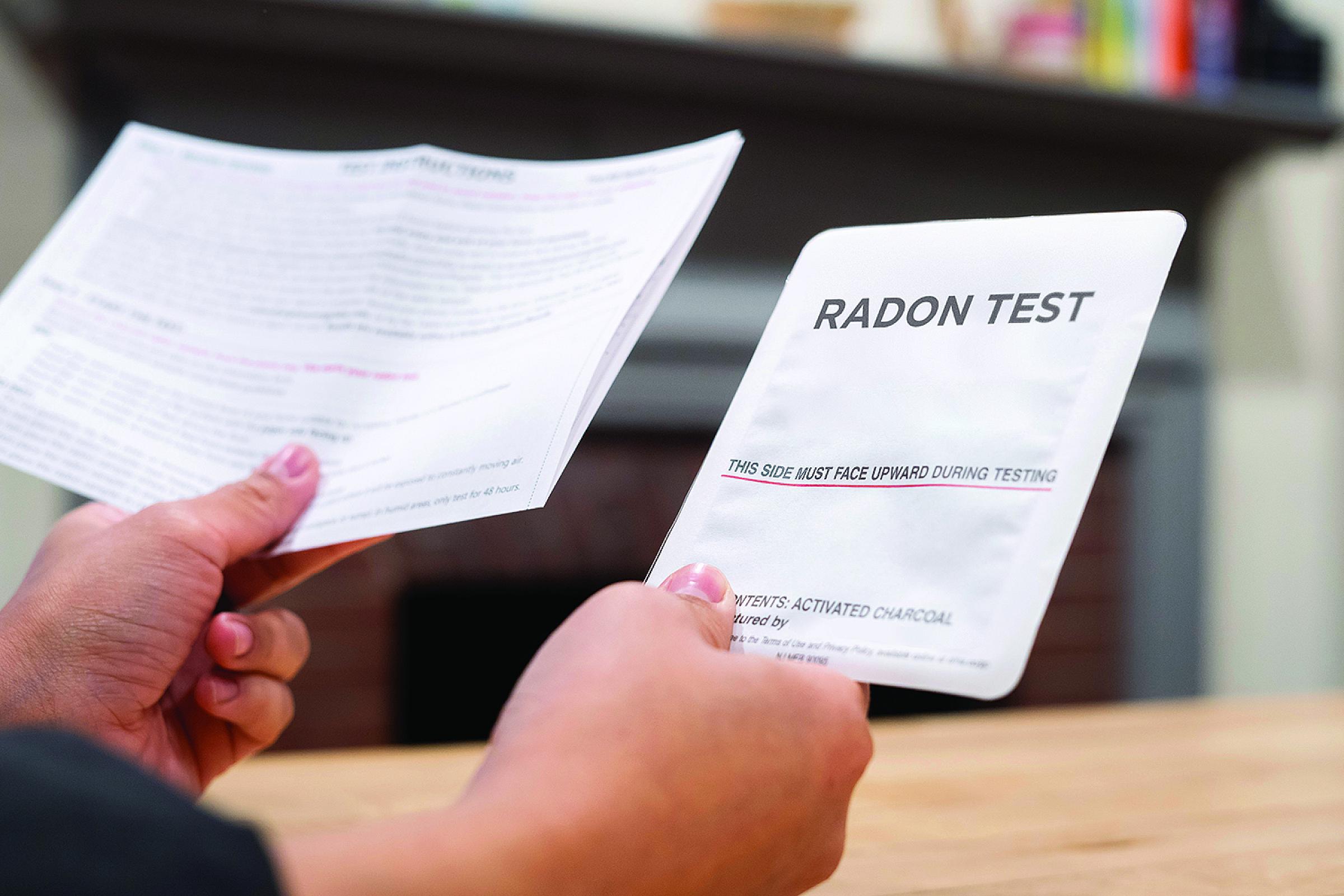 Person holding up instructions for radon test