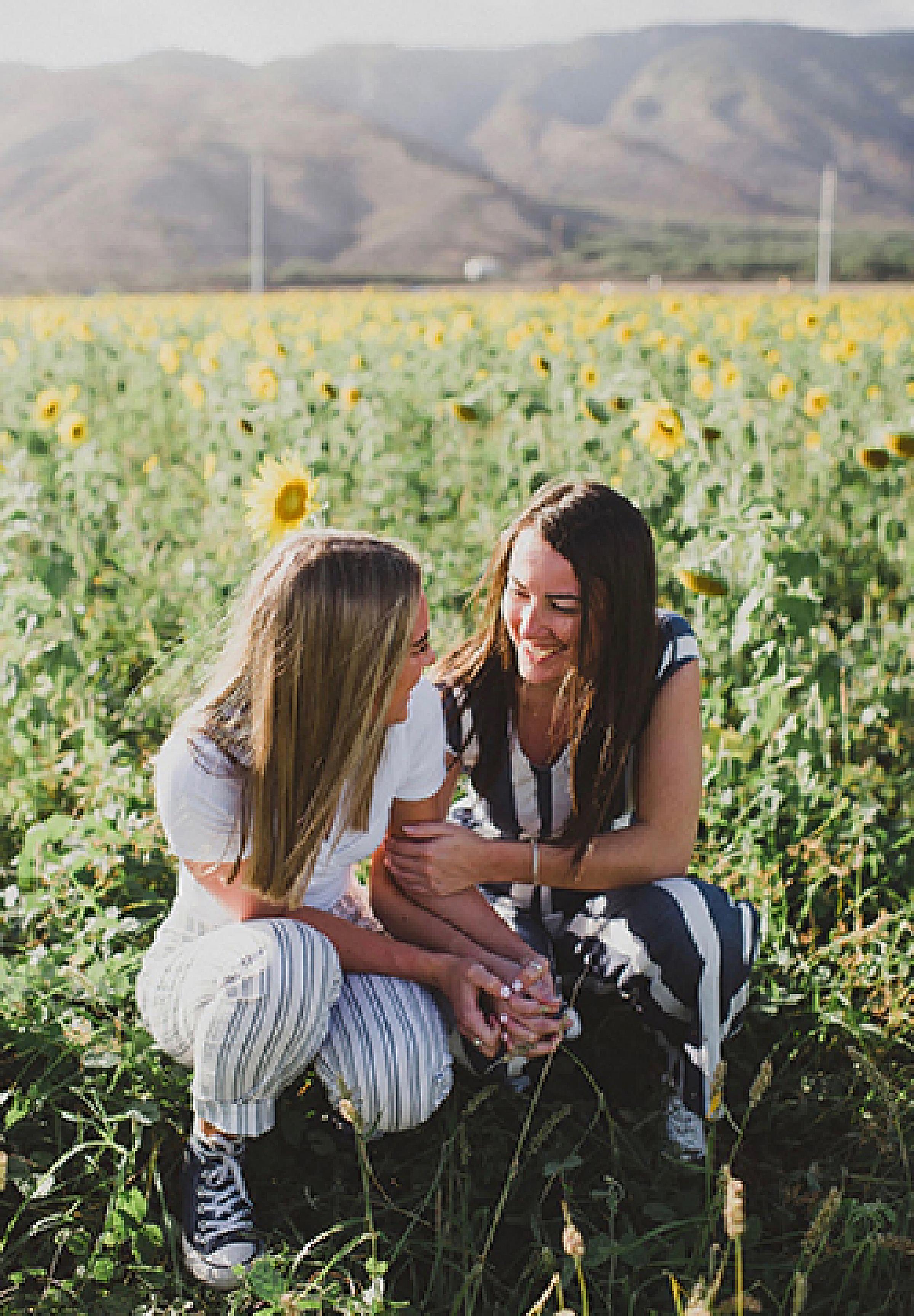 Savanna and Olivia Dubell in a field of sunflowers