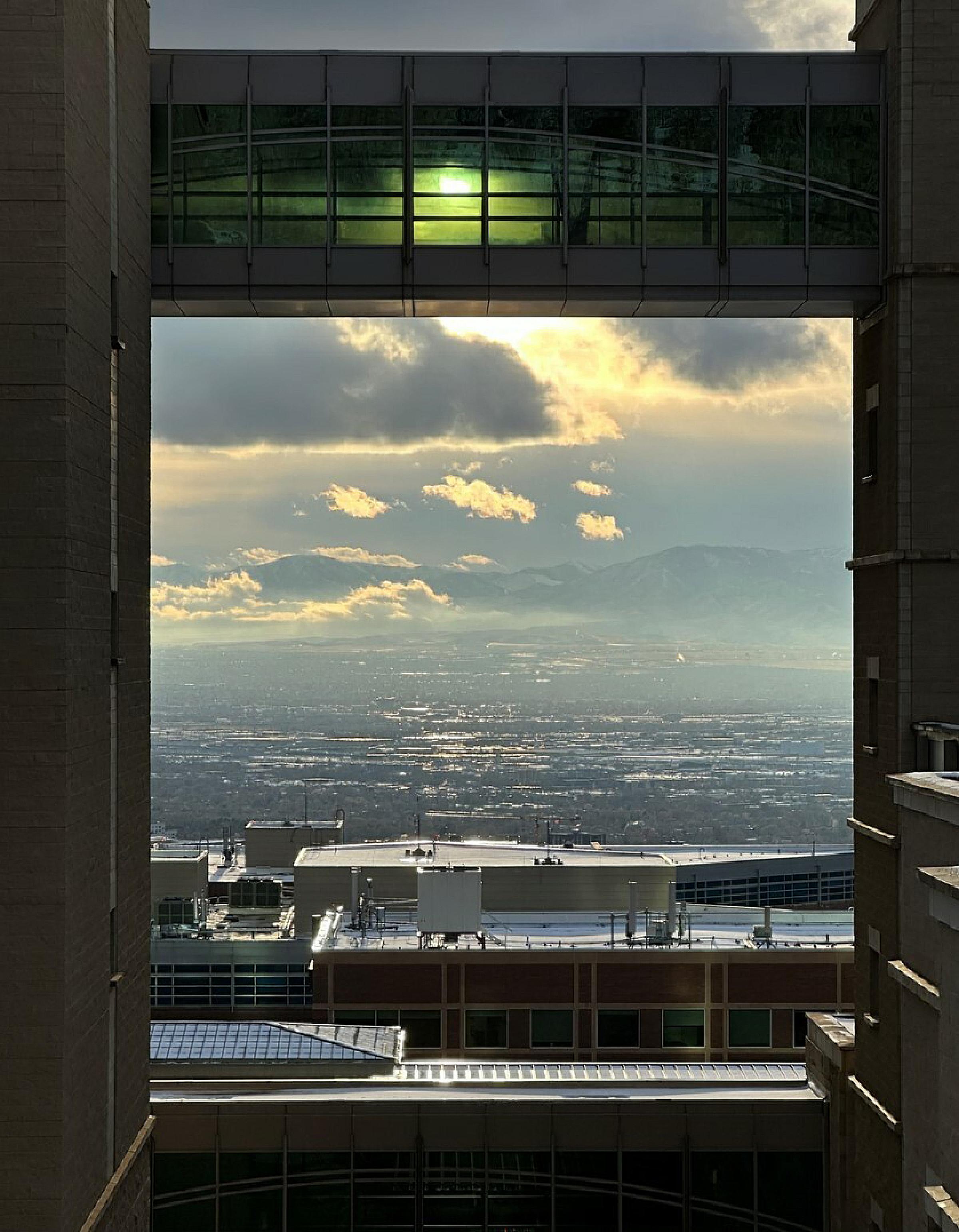 Huntsman Cancer Institute buildings and skybridge forming a window to look out at Salt Lake valley