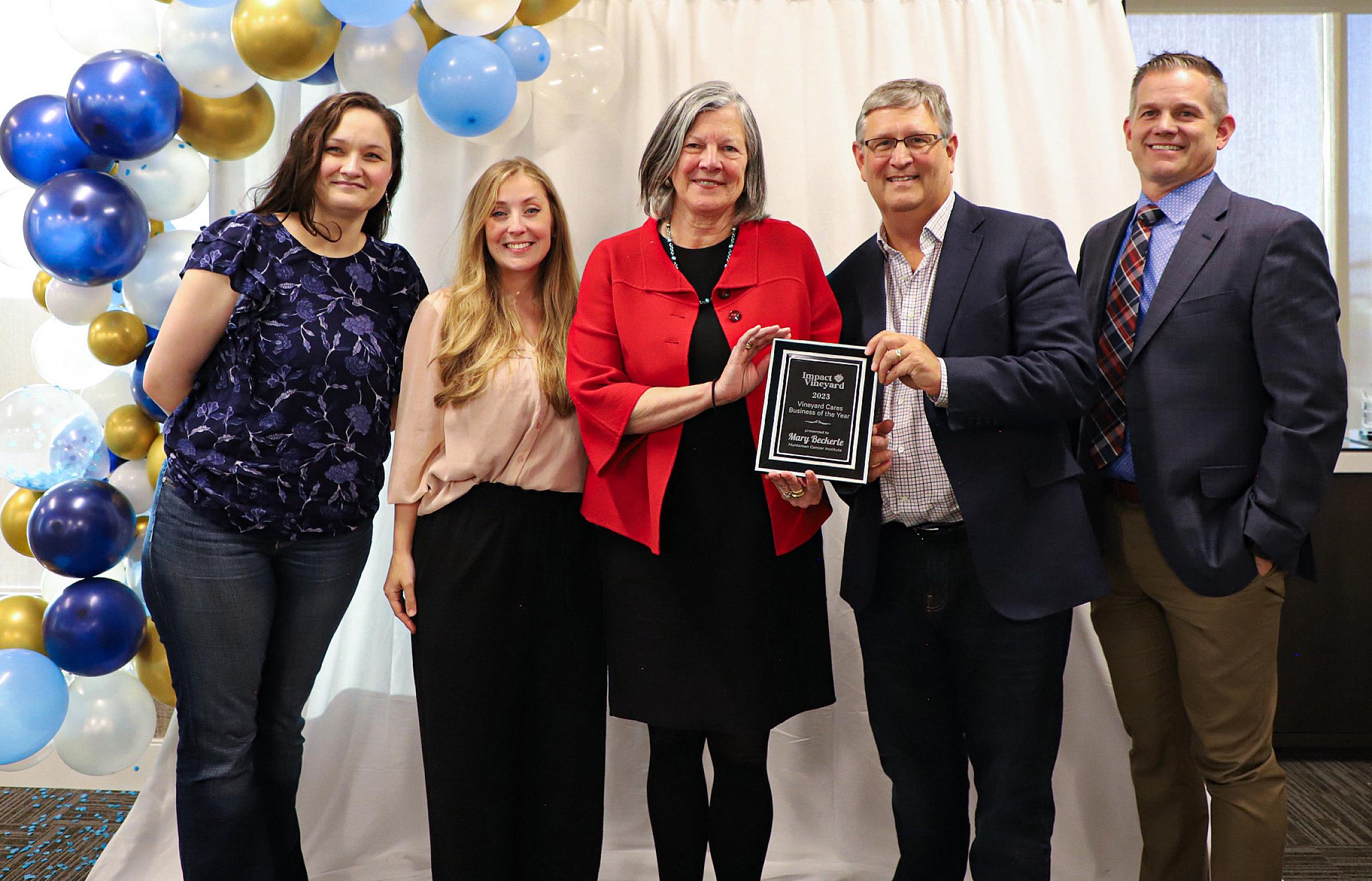 Mary Beckerle, PhD, and Brad Cairns, PhD, stand with Vineyard Mayor Julie Fullmer and other Vineyard officials as Huntsman Cancer Institute is presented the Business of the Year Award