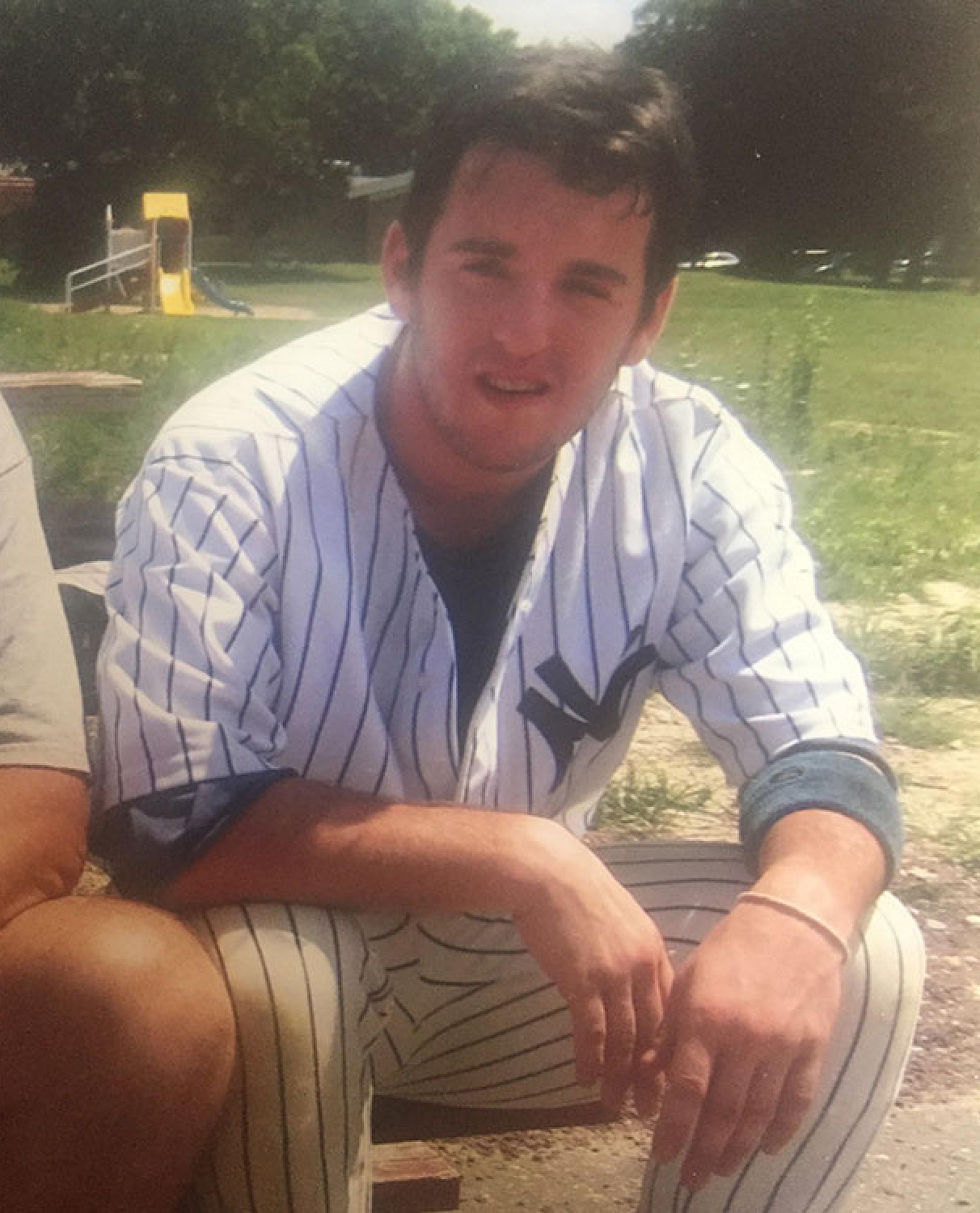 Adam Singer Sitting Outside in Baseball Uniform
