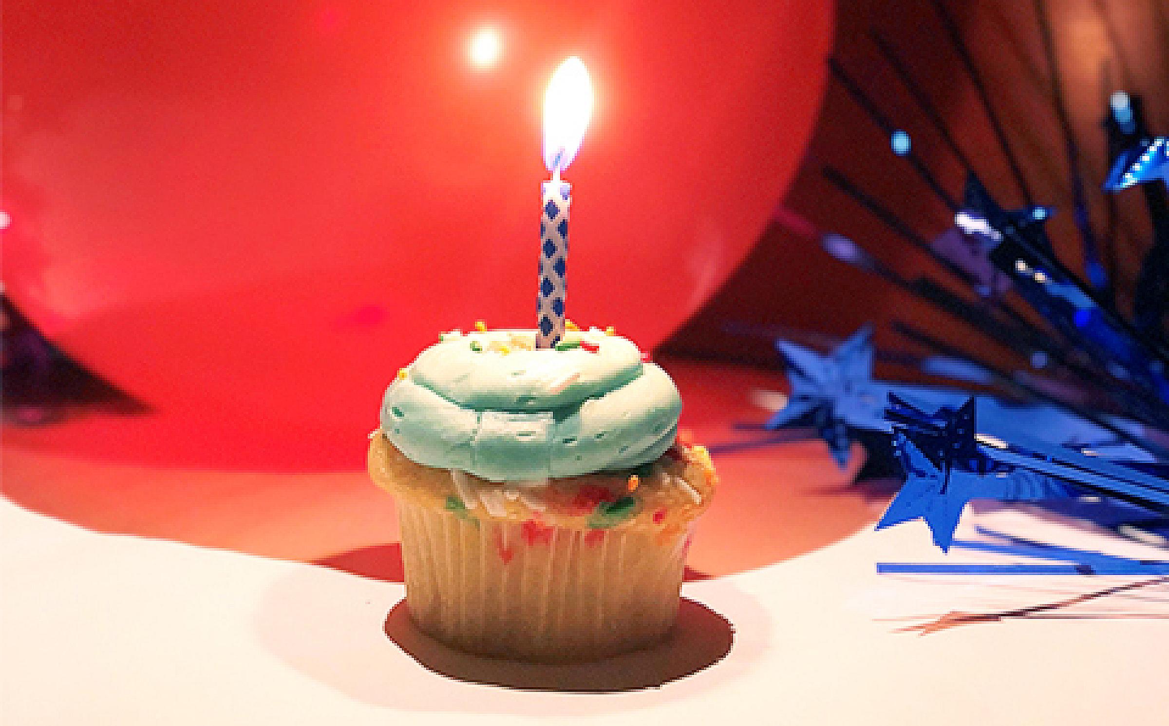Birthday cupcake with candle and balloon