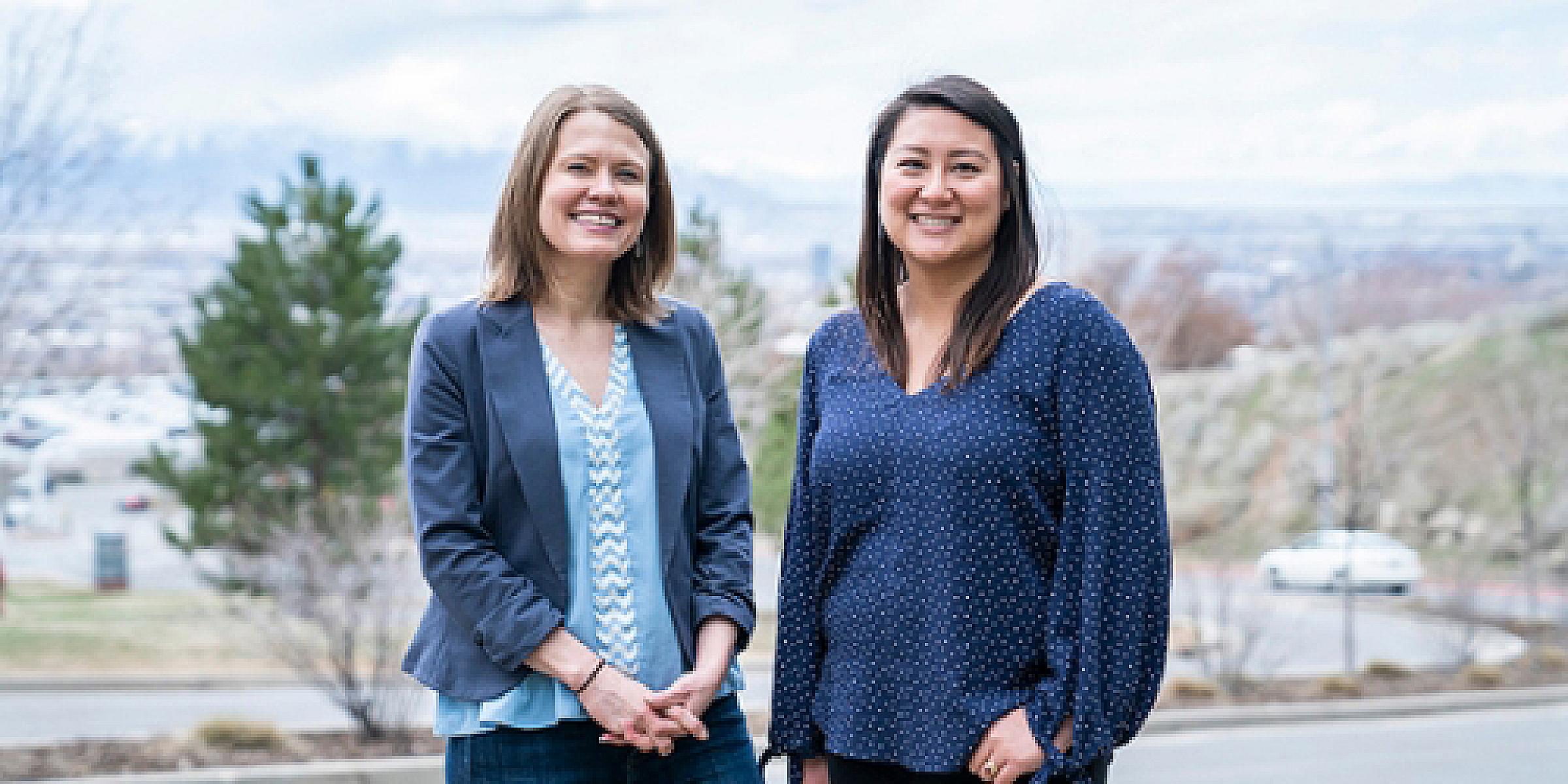 Anne Kirchhoff, PhD and Judy Ou, PhD standing in front of a view of the Salt Lake valley