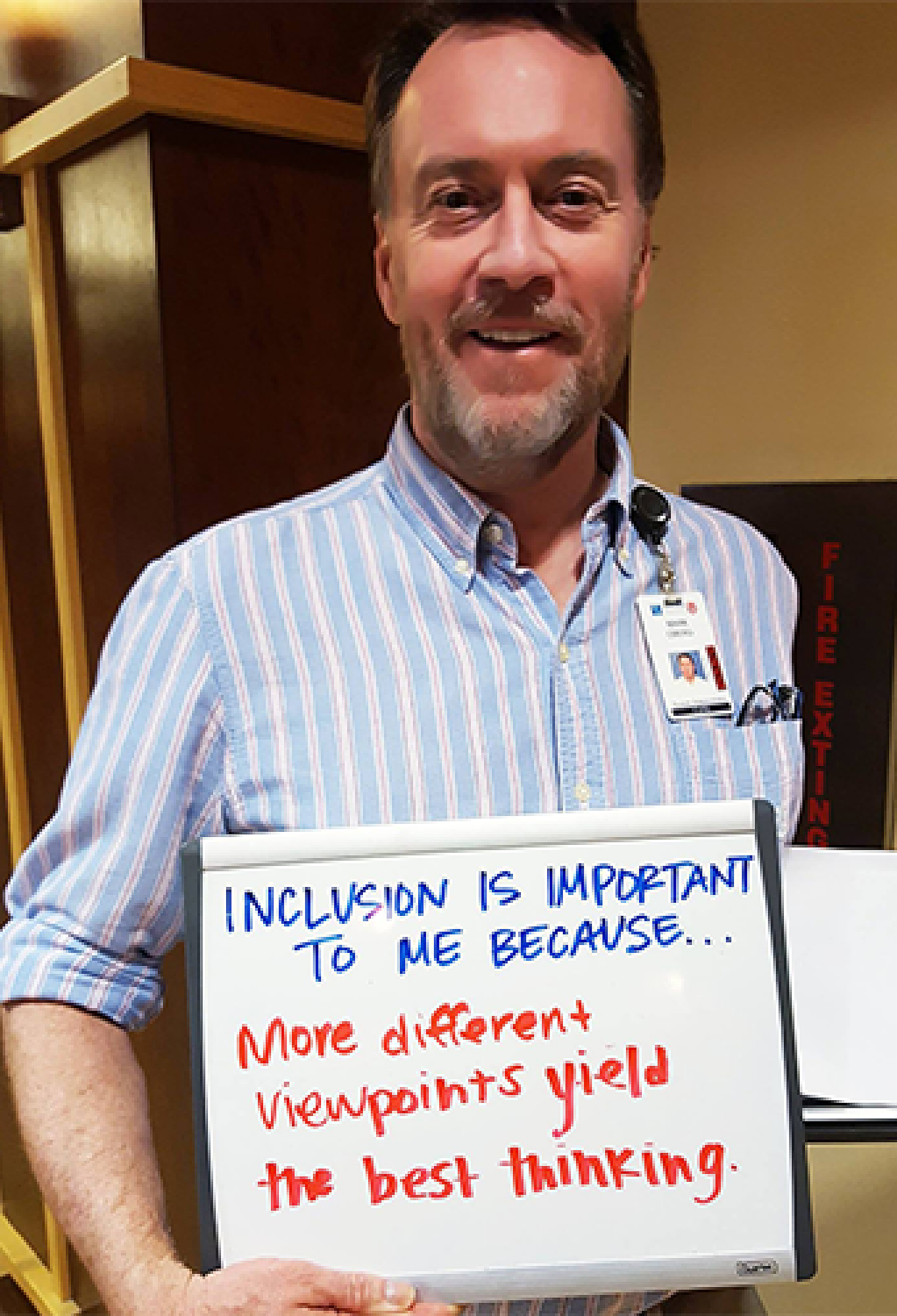 Mark Oberg holding whiteboard that reads, "Inclusion is important to me because..More different viewpoints yield the best thinking."