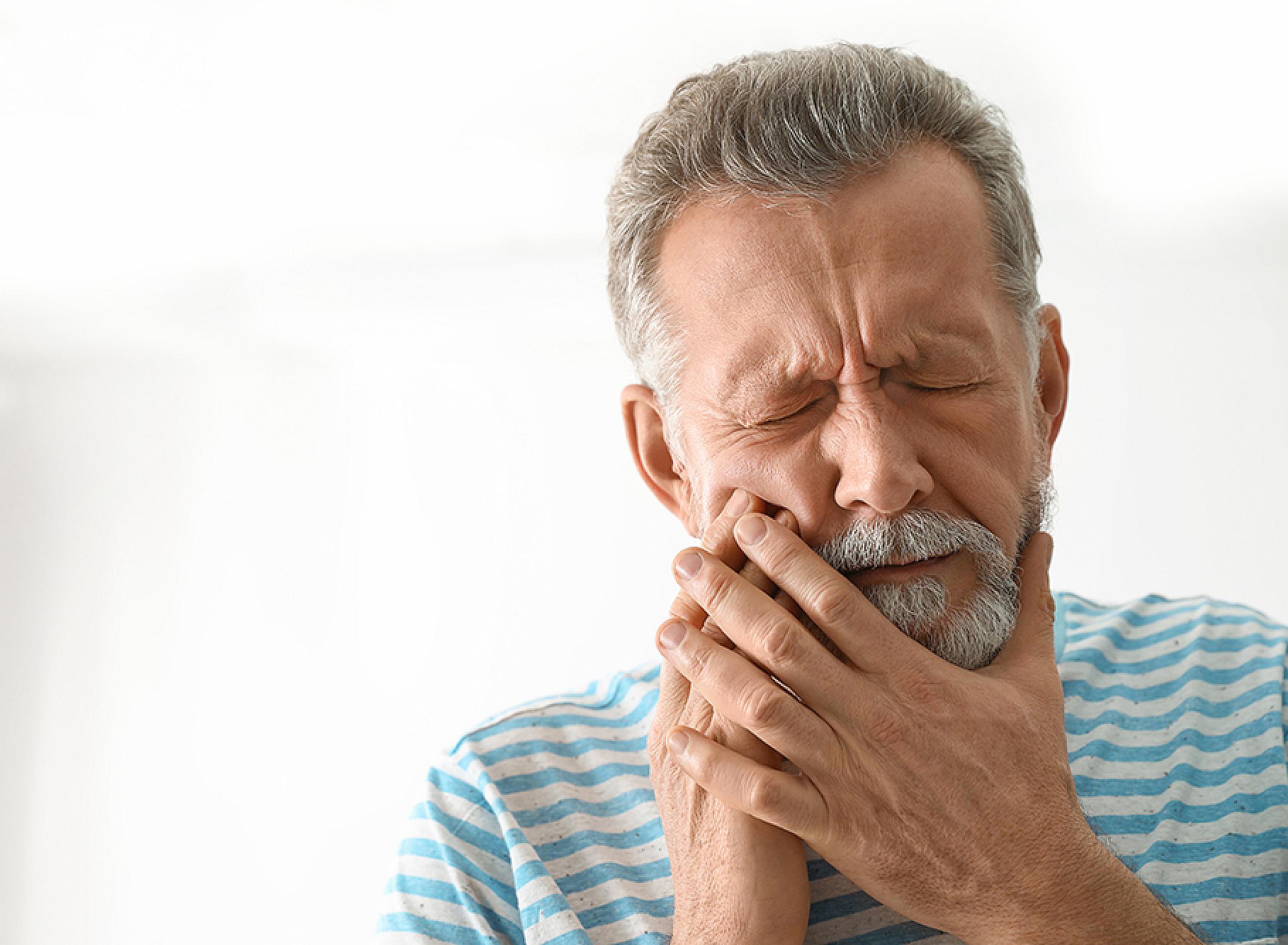 Man with Mouth Pain Holding Jaw