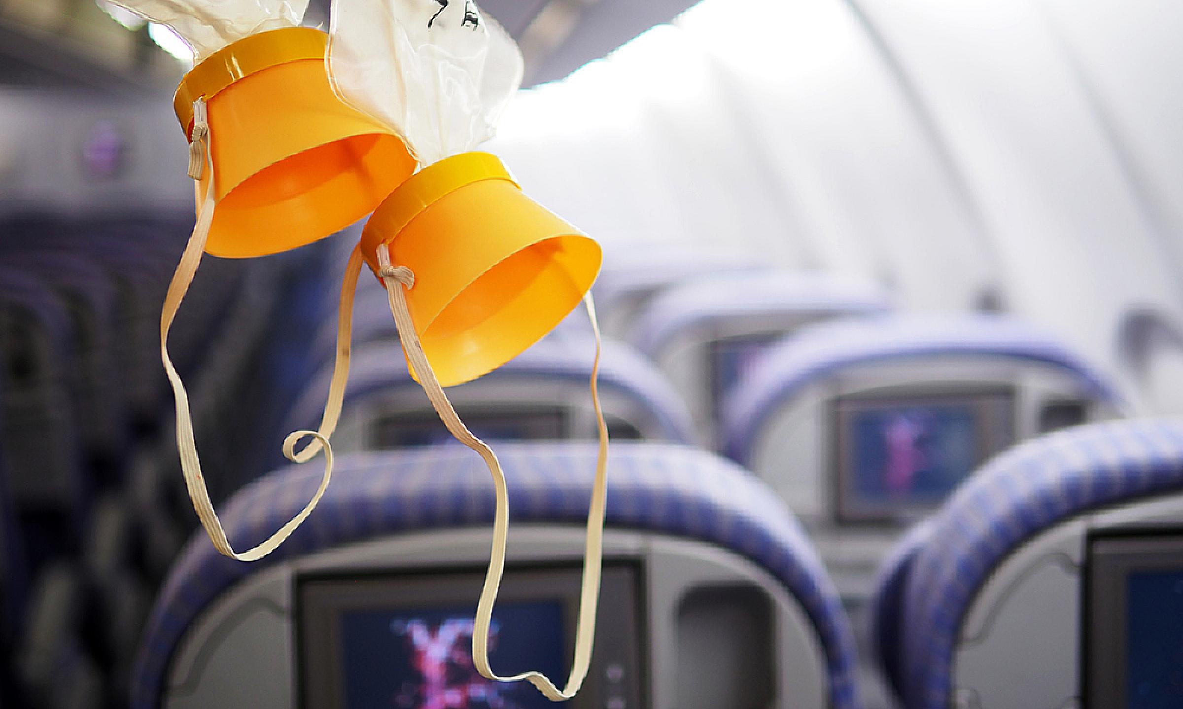 Oxygen masks hanging from ceiling of plane