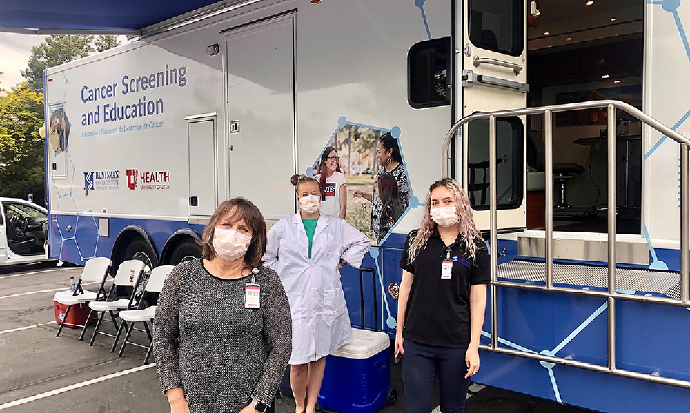 Staff members standing in front of the Cancer Screening and Education Bus