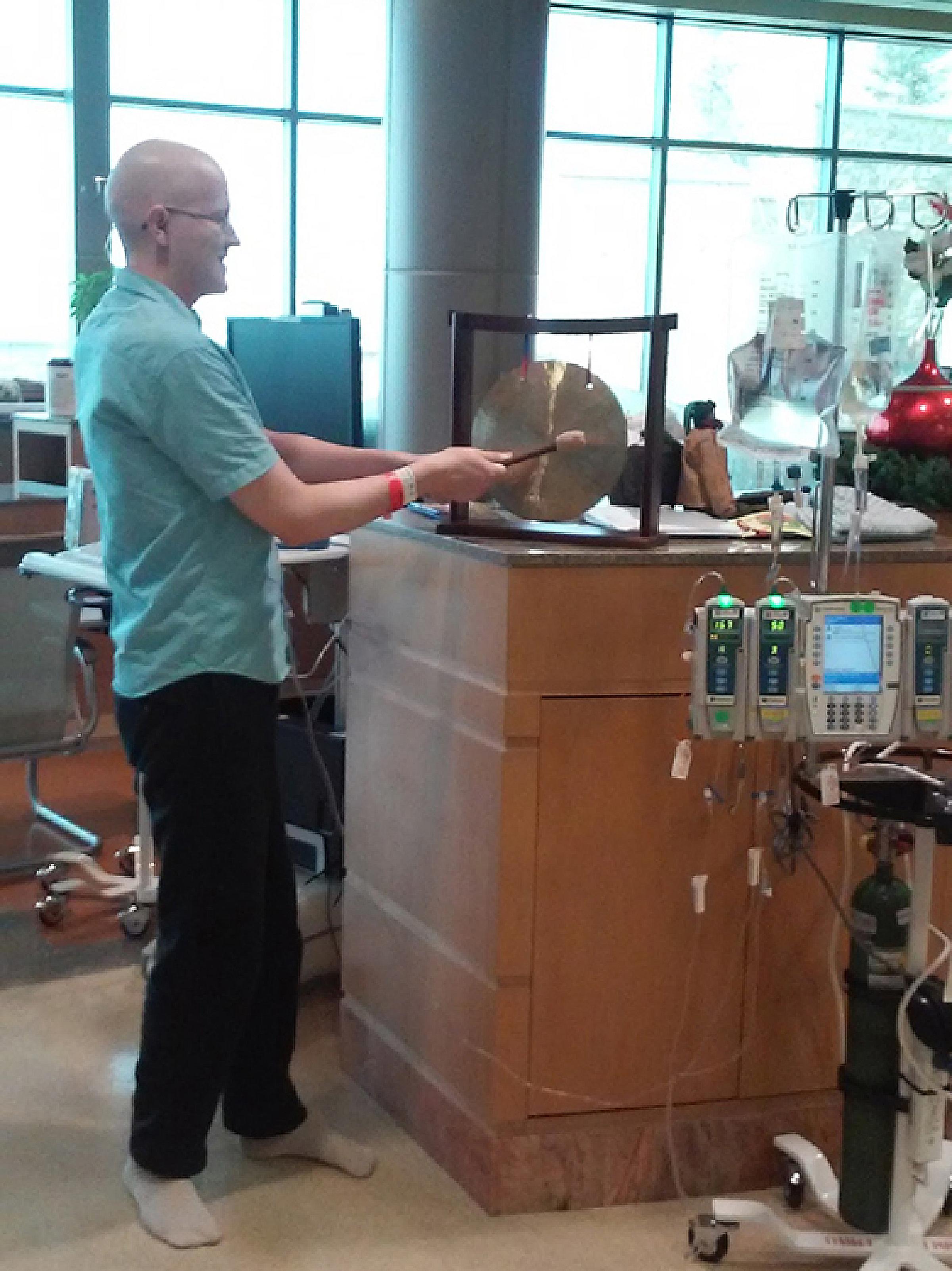 Ken Selden ringing the gong in the Infusion Center