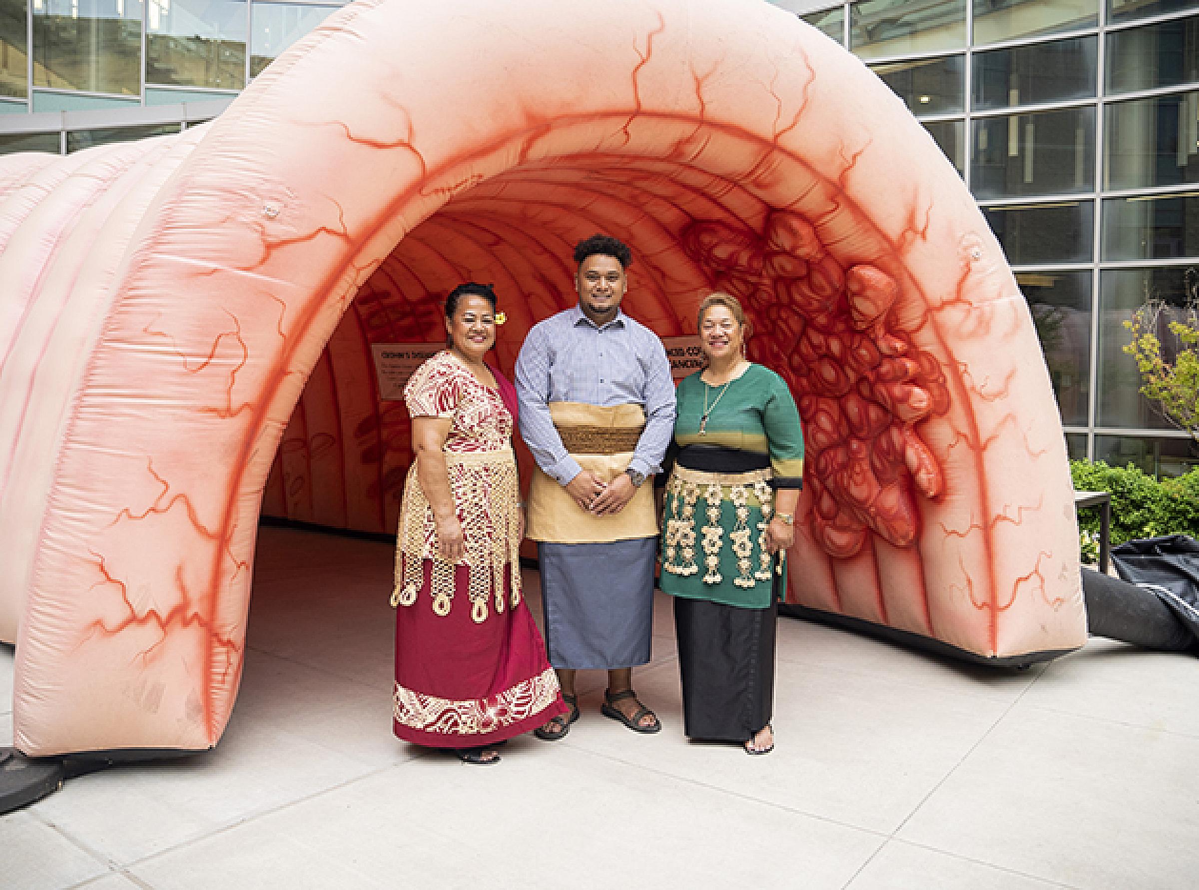 Members of the Pacific Islander Community with HCI's inflatable colon exhibit