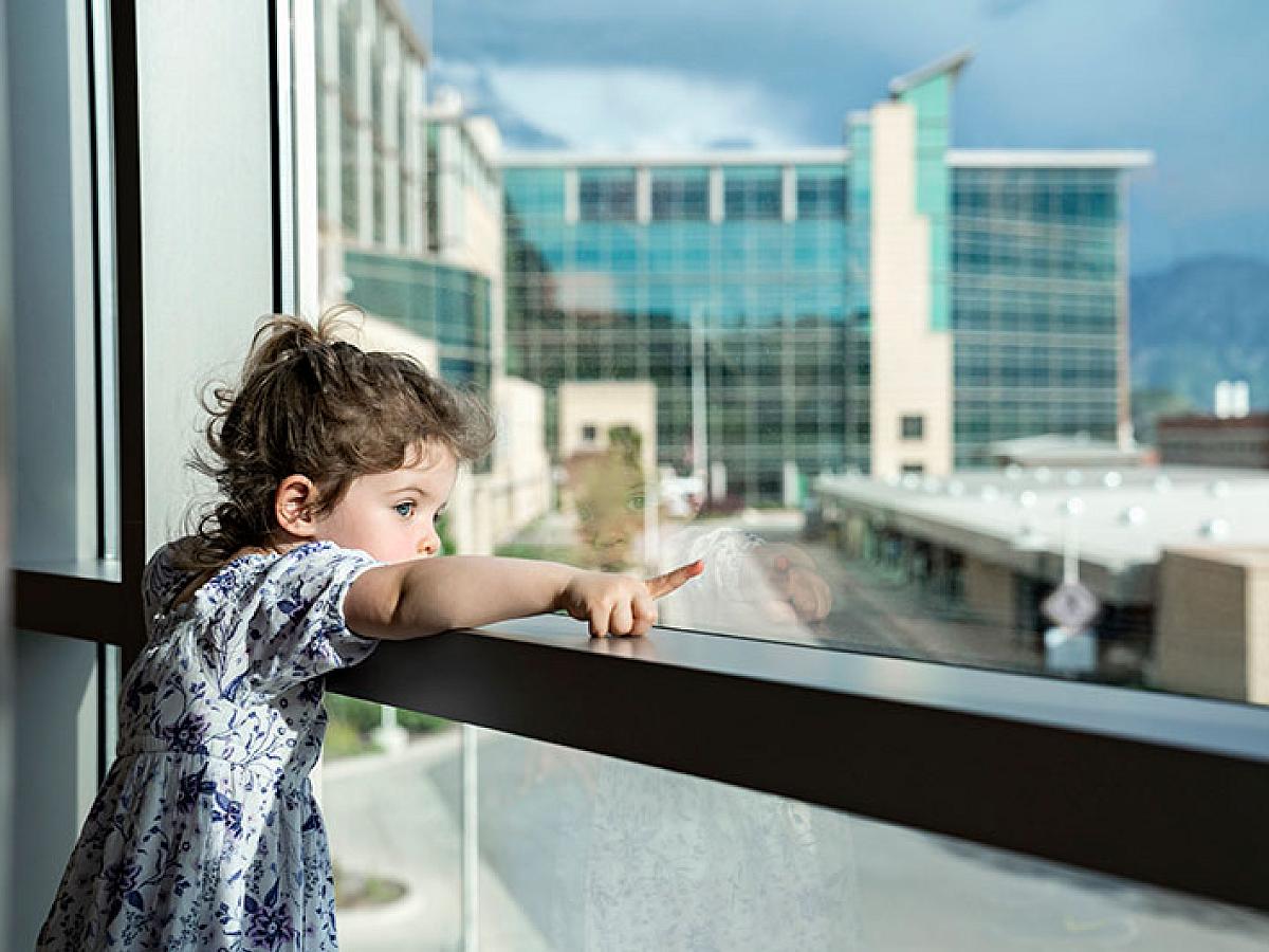 Toddler pointing out window of the hospital at Huntsman Cancer Institute