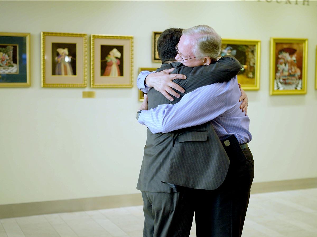 Lowry Bushnell and Jonathan Tward, MD, PhD, embrace at Huntsman Cancer Institute