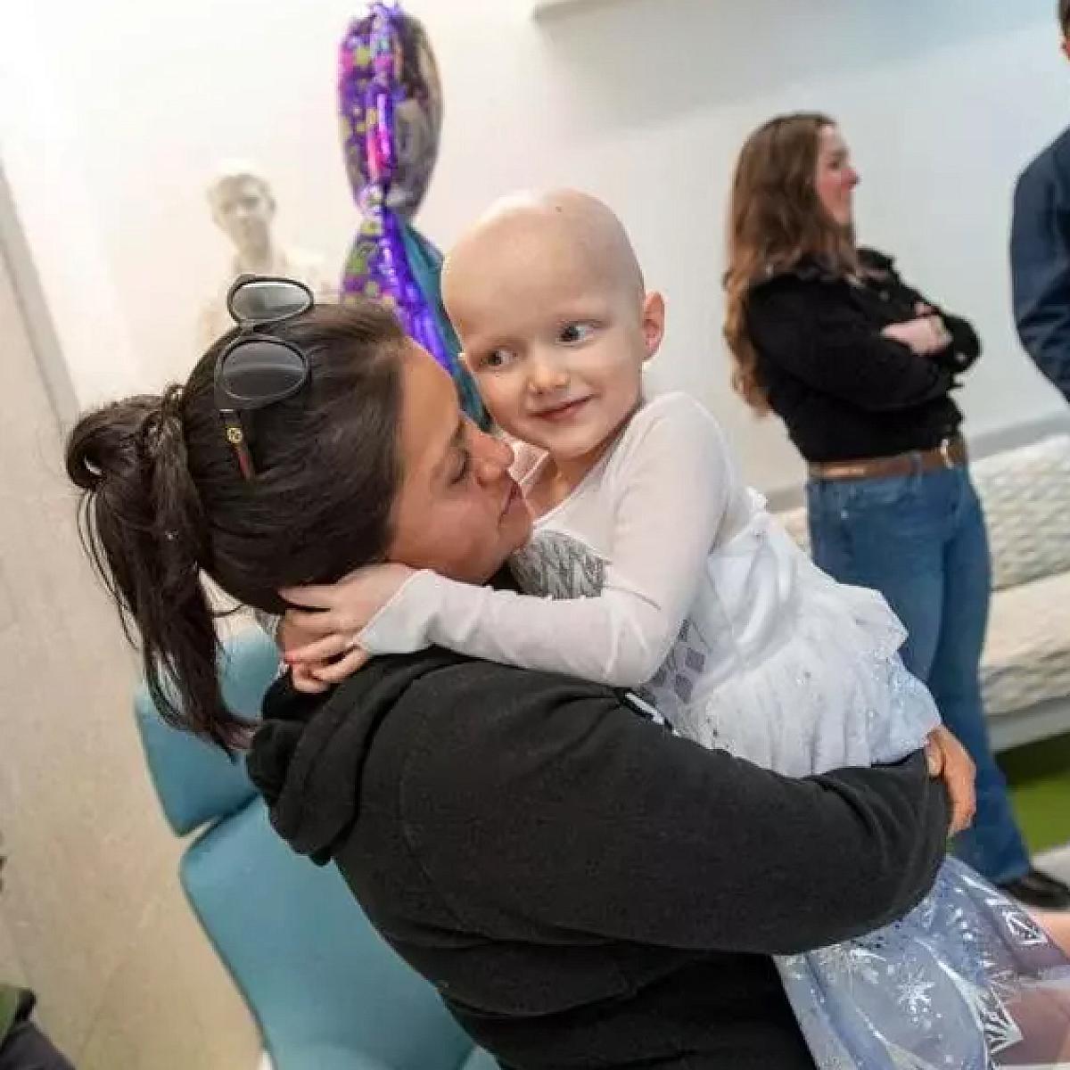 Parker getting a hug while celebrating the end of her chemotherapy treatment