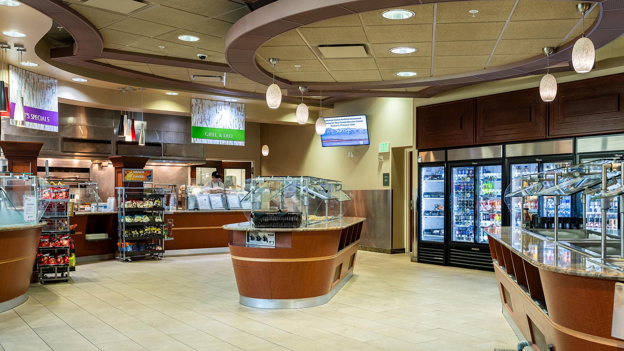 Buffet islands, refrigerators with grab and go food, and food ordering stations in The Bistro