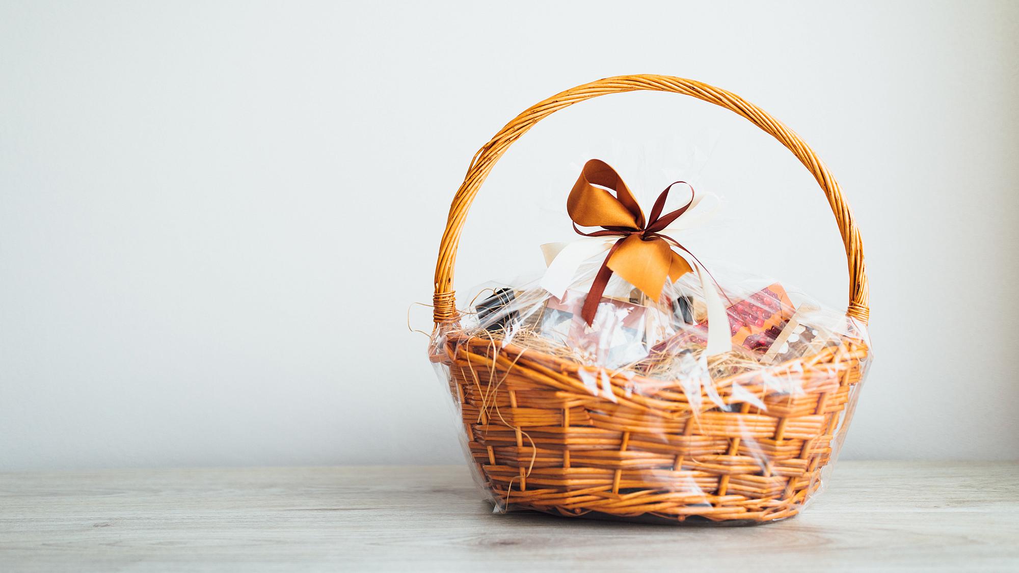 wrapped gift basket on white counter against white background
