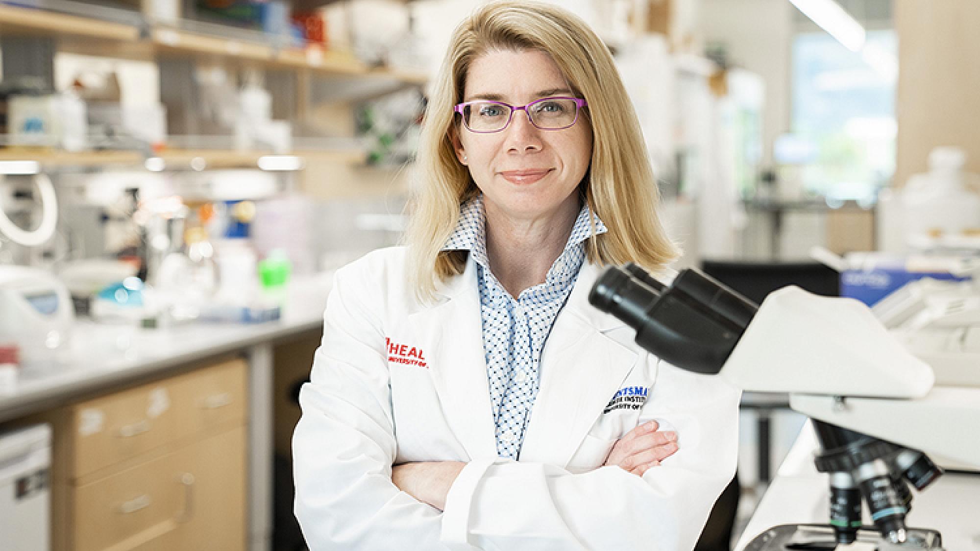 Allie Grossman posing in lab coat in research lab