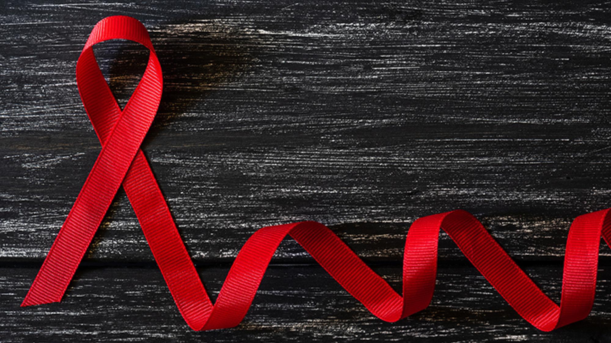 blood cancer red ribbon against black background