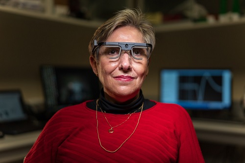 Berna Gomez wears the glasses she used to successfully test the Moran|Cortivis Visual Prosthesis, developed by John A. Moran Eye Center researcher Richard 'Dick' Normann, PhD, to create artificial vision.