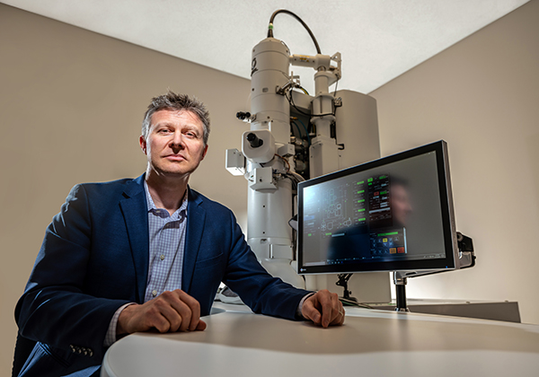 Bryan W. Jones, PhD, with his lab's new transmission electron microscope and camera funded by the Dee Foundation.