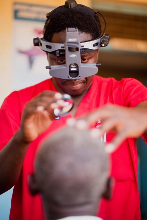 Frank Sandi, MD, the only ophthalmologist teaching at the University of Dodoma in Tanzania, examines a patient during a clinic in February in partnership with the John A. Moran Eye Center global outreach team.