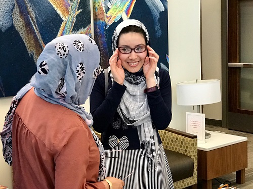 A patient picks out frames for a new pair of prescription glasses after having an examination at Moran Eye Center's Refugee Eye Care Clinic on April 27. 