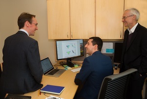 Moussa Zouache, PhD, center, talks with fellow SCTM collaborators, Tiarnan Keenan, MD, PhD, left, and Philip Luthert, MBBS, FRCP, FRCPath, FRCOphth.