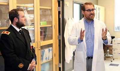 Colin Bretz, MS, PhD, talks about his research during a tour of the National Institutes of Health-funded lab of top retinal research Mary Elizabeth Hartnett, MD, where he works.