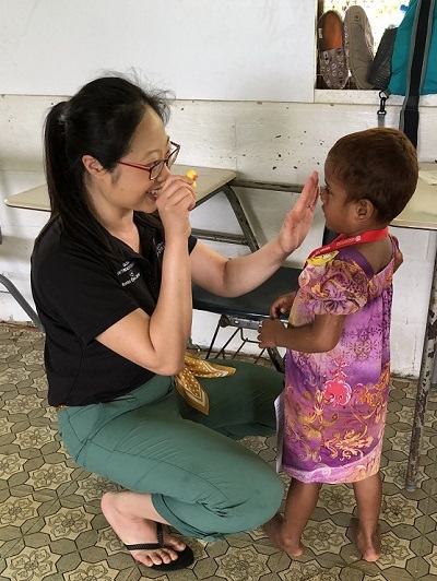 Sophia Y. Fang, MD, MAS, examines a child during a Moran Eye Center Global Outreach eye care clinic in Micronesia in the spring.