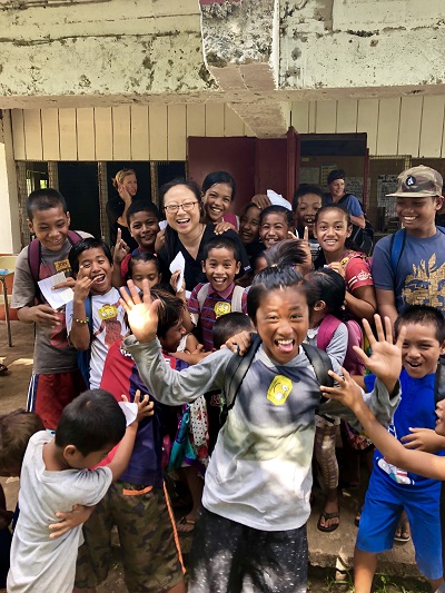 Sophia Y. Fang, MD, MAS, with a group of schoolchildren in Micronesia during a Moran Eye Center Global Outreach Division trip in the spring.