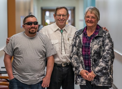 Cardon Slade, left, and his mom Donna are pictured with Alan S. Crandall, MD, following a post-operation checkup at the Monument Valley clinic.