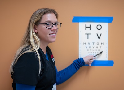 Volunteer Lily Hudson, a granddaughter of founding donor John A. Moran, assists with pediatric eye exams at the Monument Valley clinic.