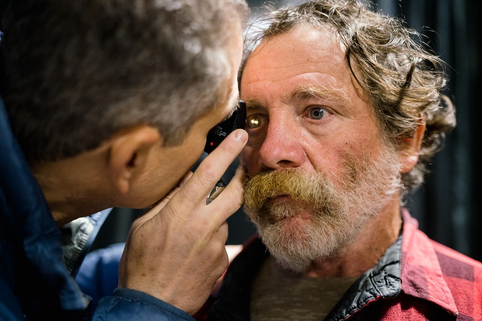 Moran physician Bradley J. Katz examines a patient at the 2019 annual Project Homeless Connect event in Salt Lake City.